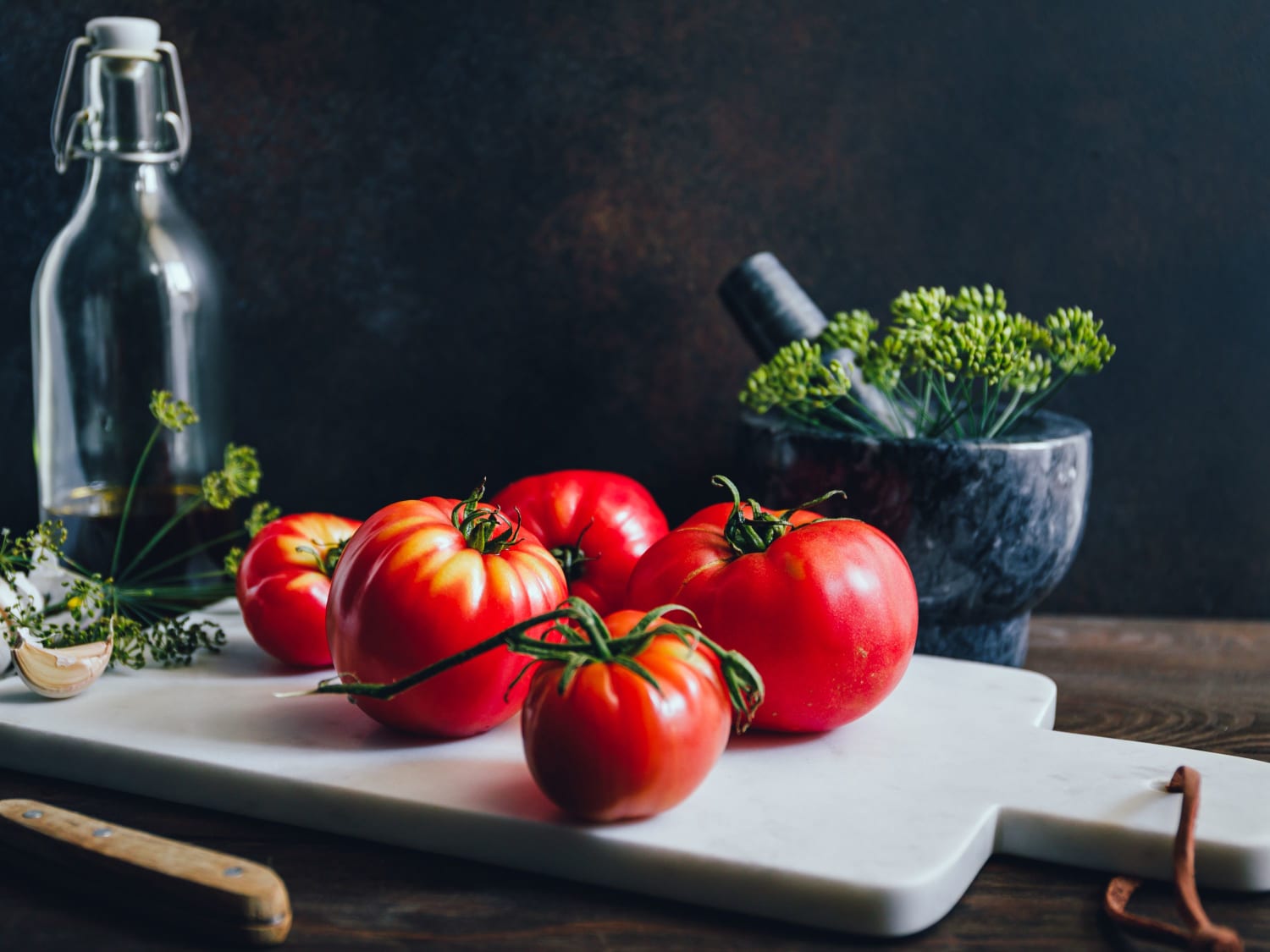 a chopping board with tomatoes